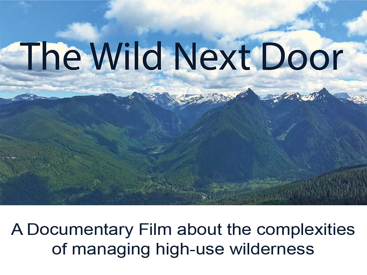 Lake and mountains with film title hovering in center frame.